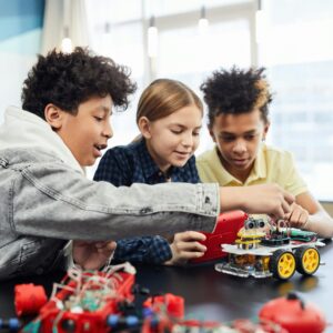 Children collaborating on an electronic robotics project, fostering teamwork and innovation.